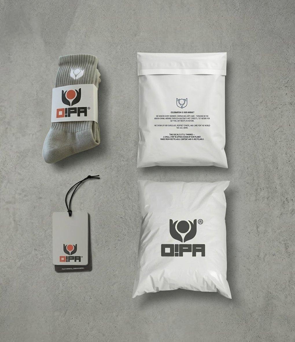 O!PA socks with a paper band, a recyclable hang tag and two mailer bags